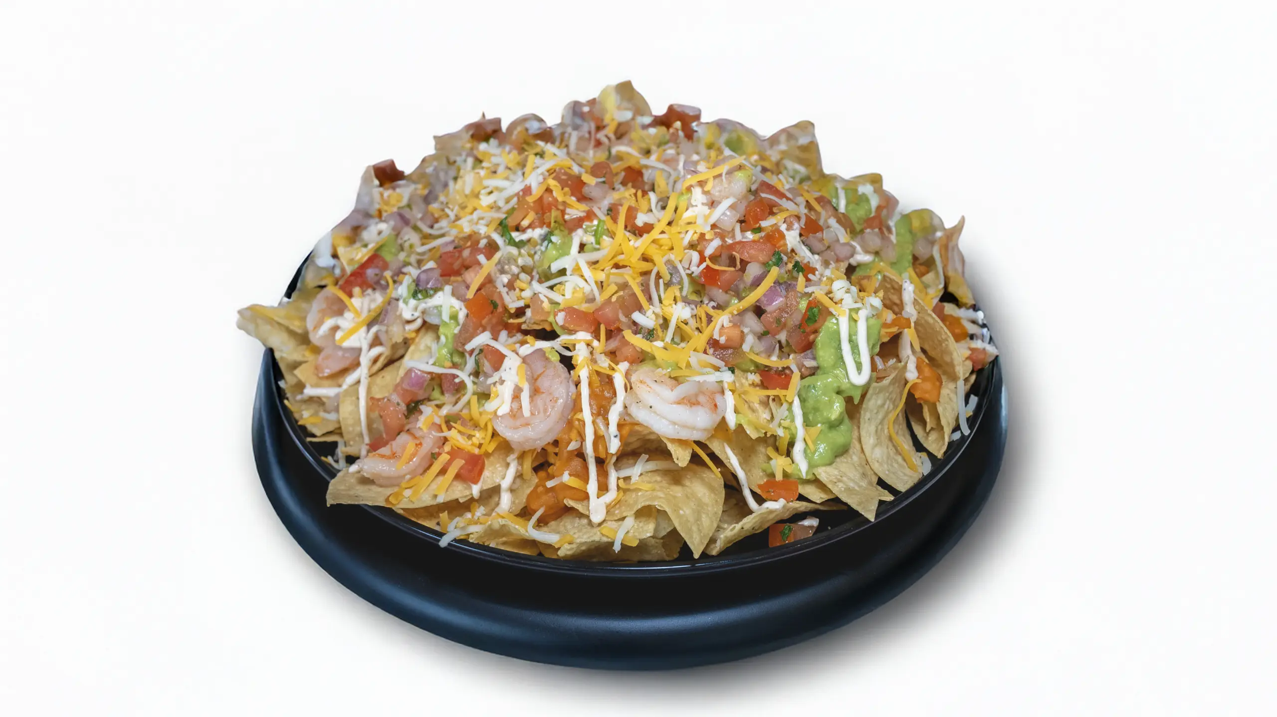Shrimp Nachos topped with pico de gallo, guacamole, and cheese